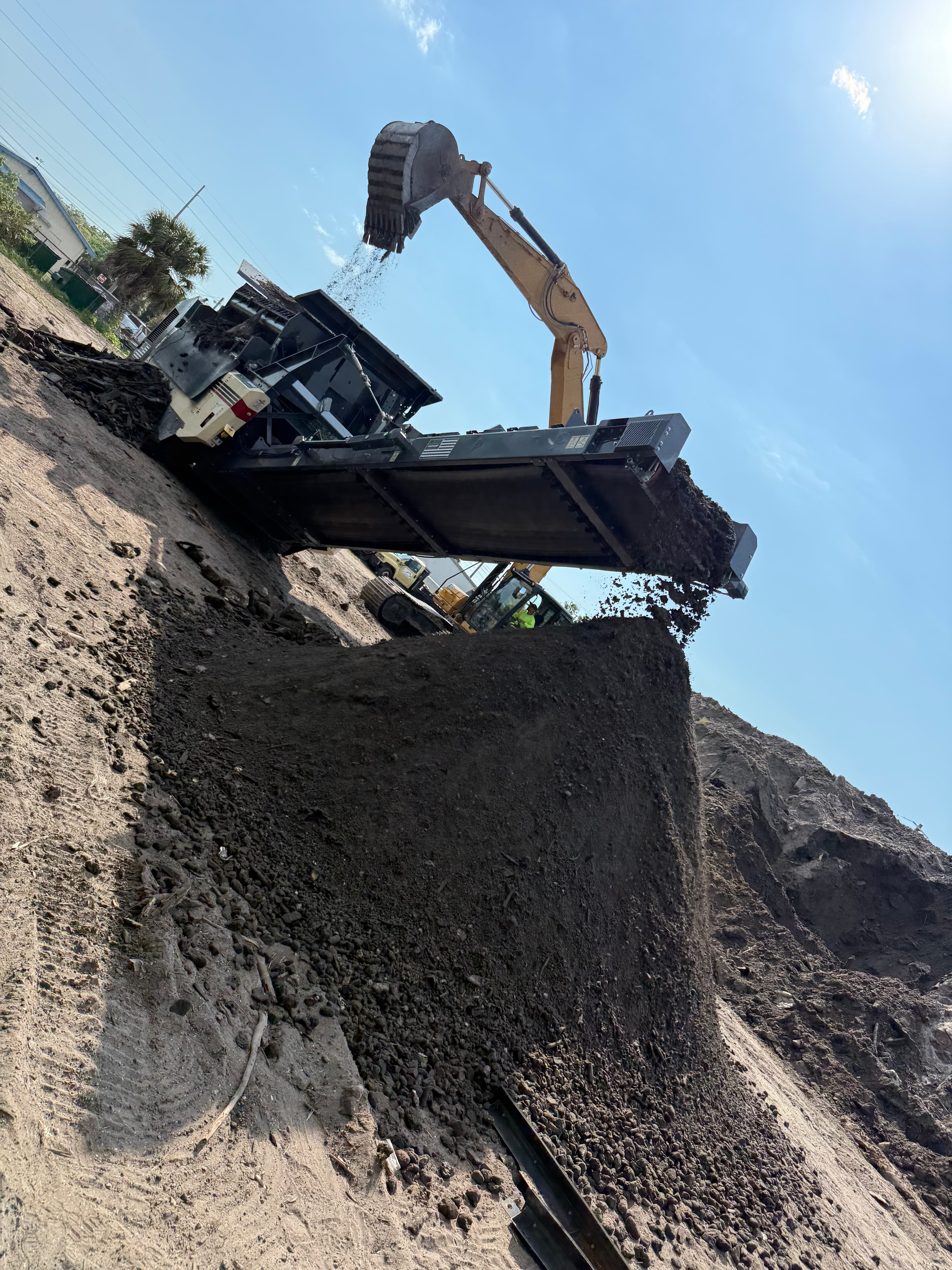 Commercial site grading with an excavator in Tampa Bay