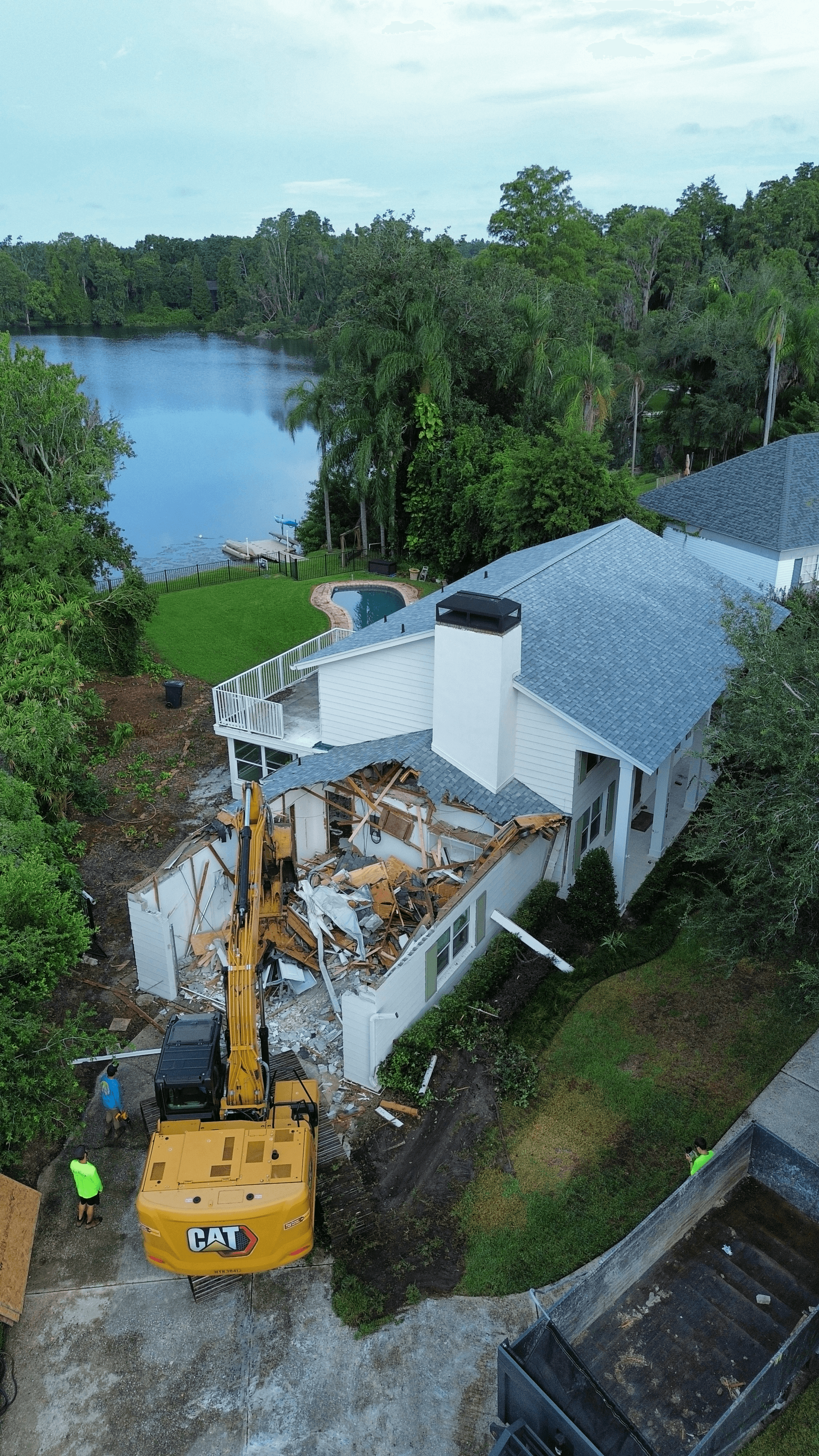 Mojo excavator working on a waterfront Tampa Bay demolition project