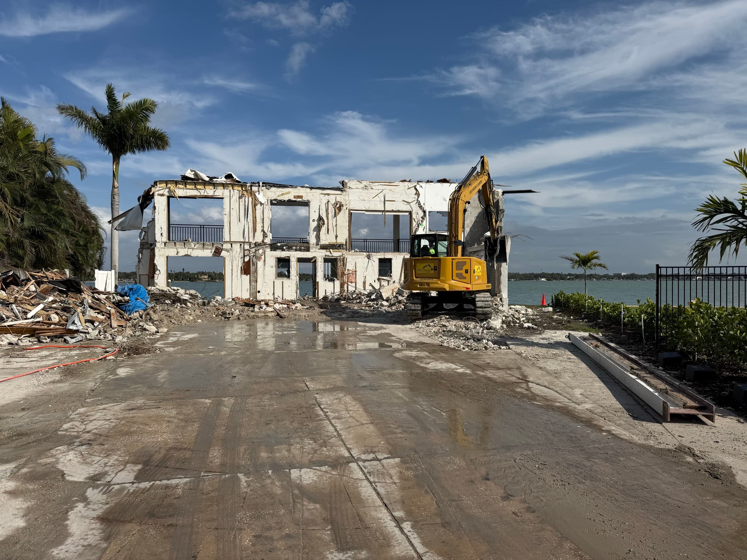 Mojo equipment clearing concrete and rubble on a waterfront project